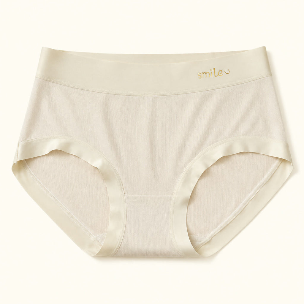 LYNE Seamless Modal Brief in Sand, flat lay showing the gold smile waistband mark and satin leg binding