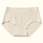 LYNE Seamless Modal Brief in Sand, flat lay showing the gold smile waistband mark and satin leg binding