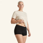 LYNE Under-Dress Safety Short in Black, three-quarter view showing the seamless side