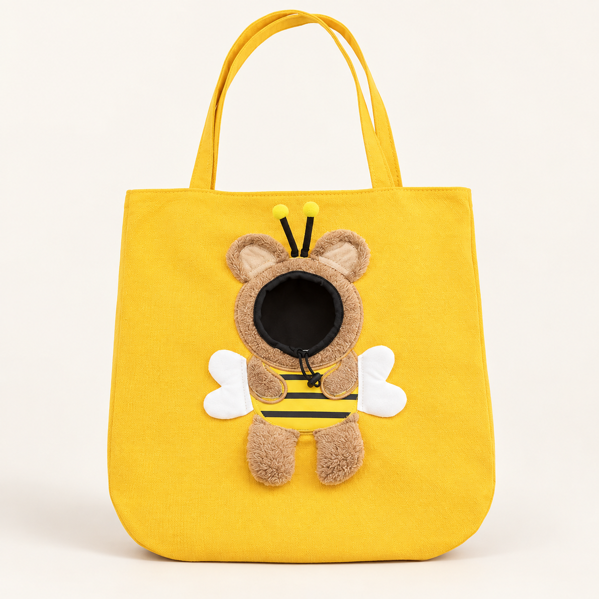 Yellow Bee pet tote with plush wings and a round front opening