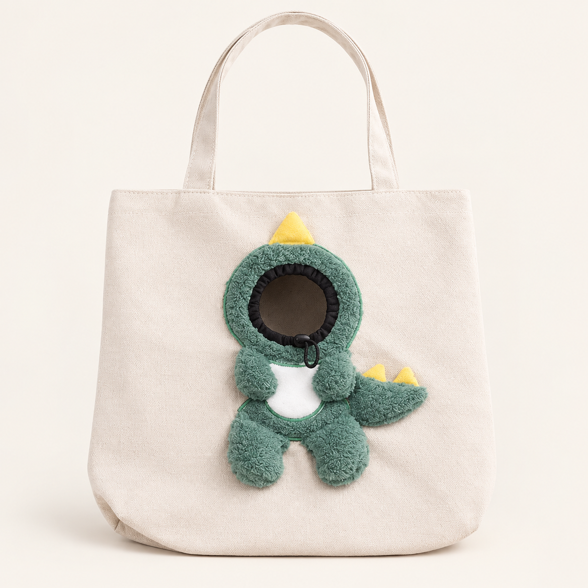 Ivory Dino pet tote with green dinosaur details and yellow spikes