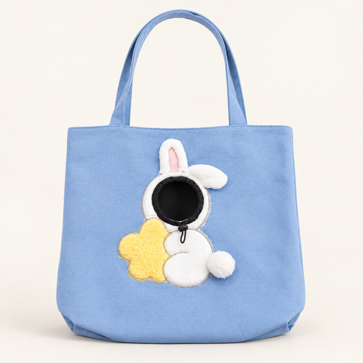 Blue Rabbit pet tote with white bunny details and a yellow flower