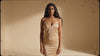 A model lowering a slip dress to reveal a seamless shapewear bodysuit underneath